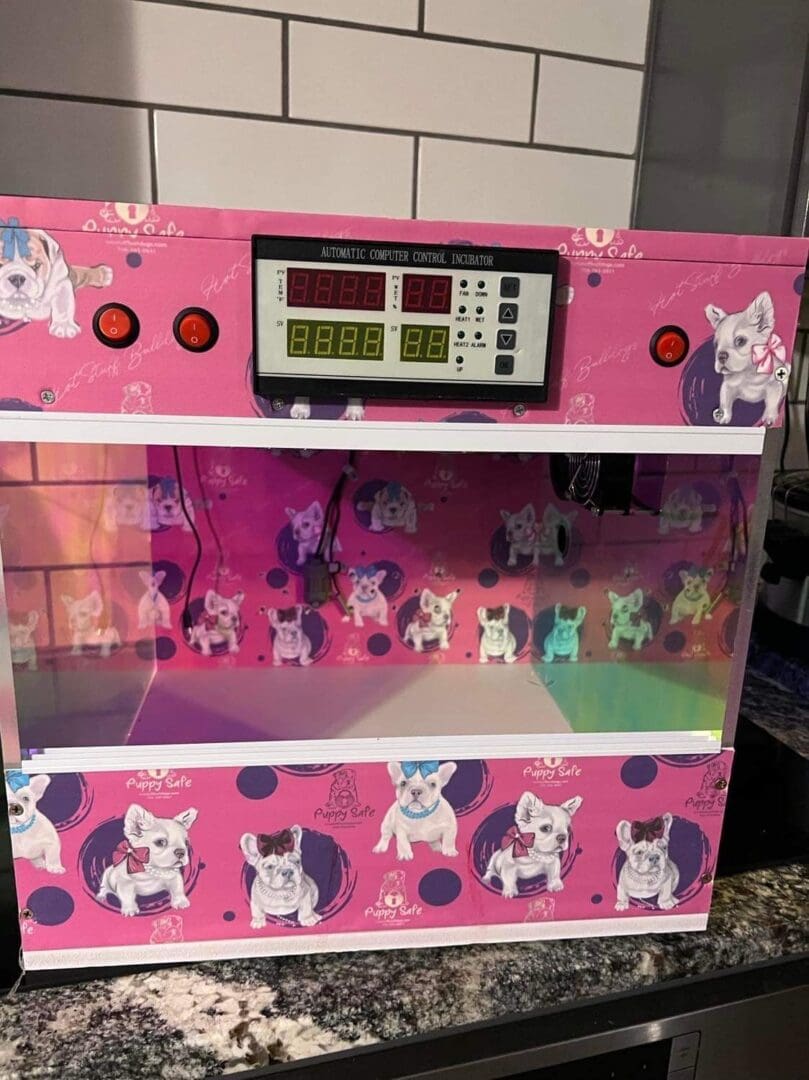 A pink machine with pictures of dogs on it.