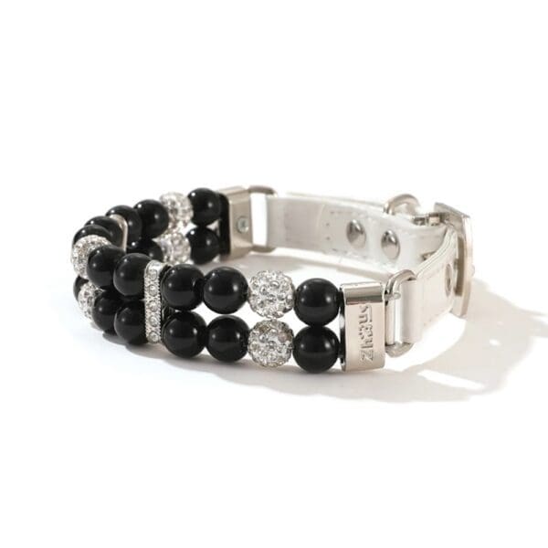 A black and white bracelet with two rows of beads.