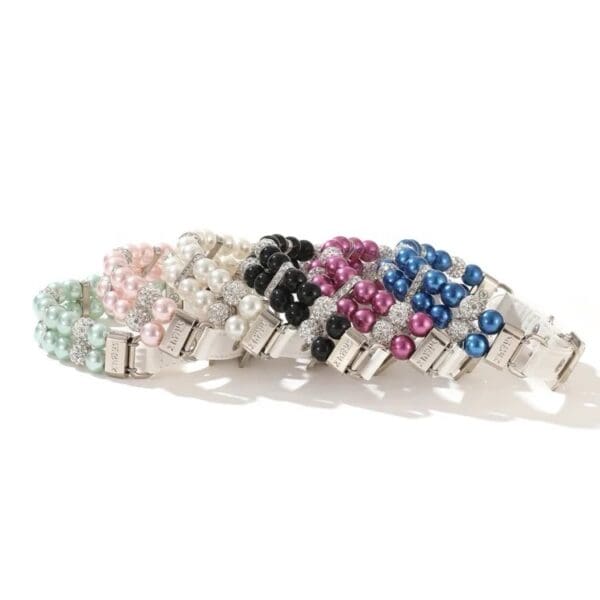 A row of different colored bracelets sitting on top of each other.