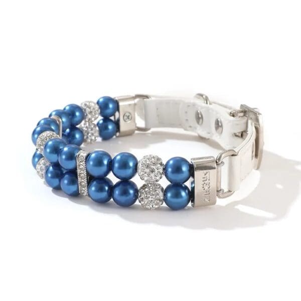 A blue bracelet with pearls and rhinestones.